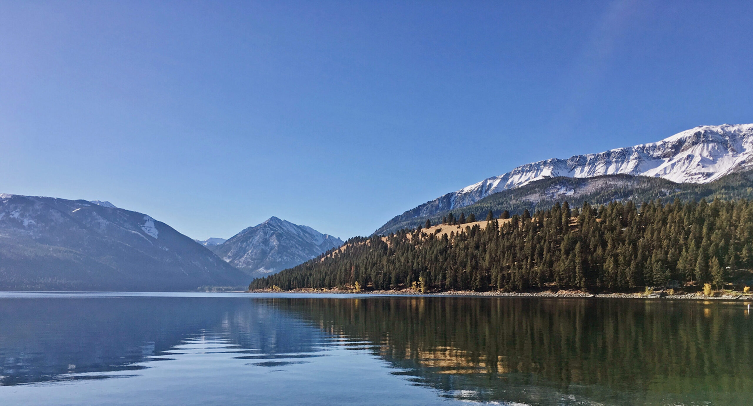 View of Wallowa mountain in Oregon, from across a peaceful lake.