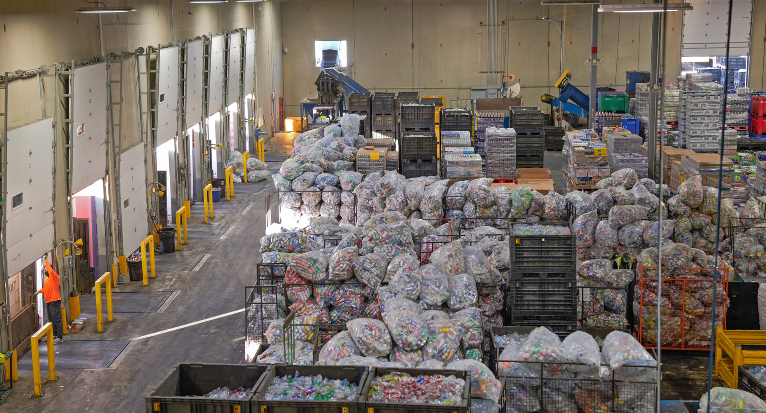 The Oregon Beverage Recycling Cooperative plant full of bags of recyclable containers.