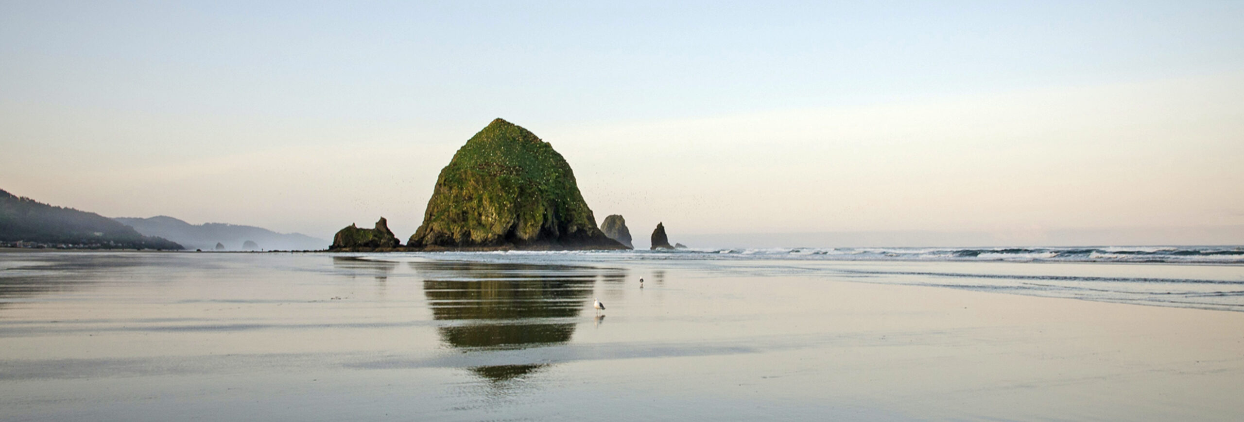 A peaceful scene of Haystack Rock at Cannon Beach, Oregon.
