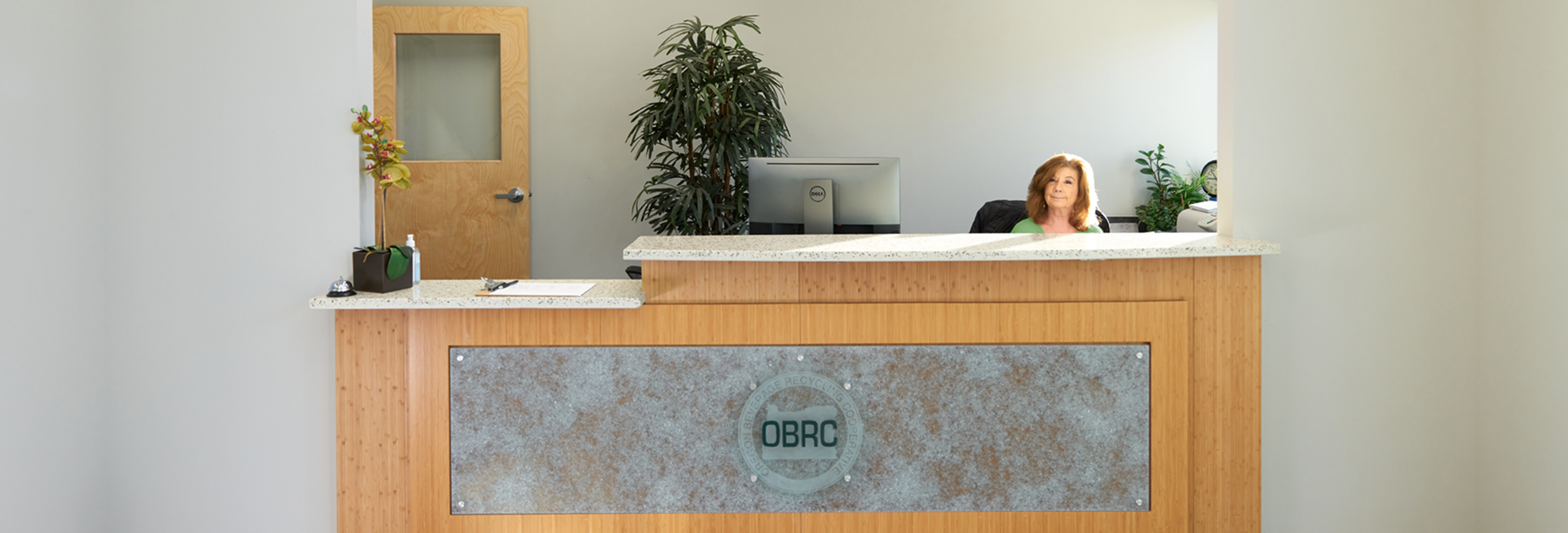 A receptionist sitting behind the front desk at the OBRC headquarters.